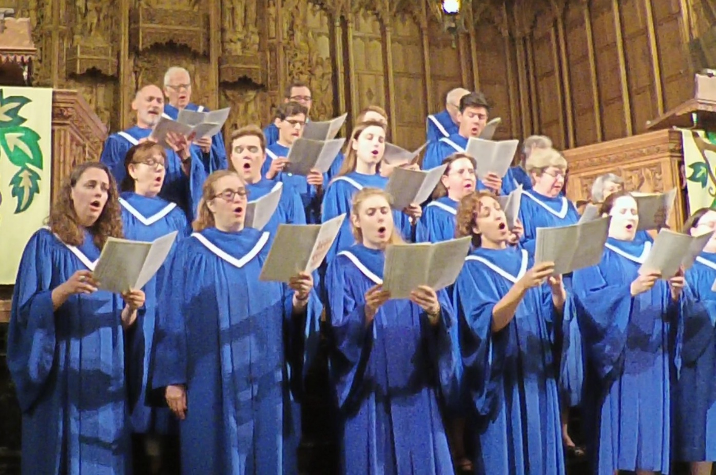 Choir members in blue robes lead worship