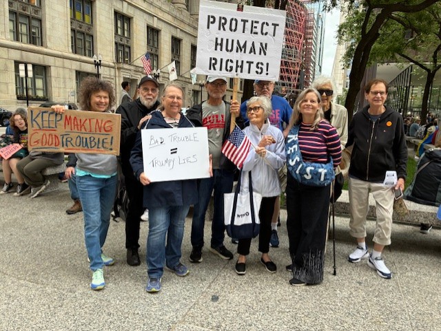 three people smiling at the camera